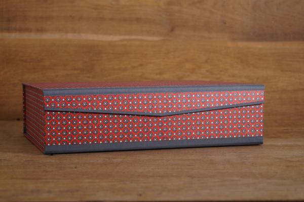 Noble box of red flowers stylized by hand